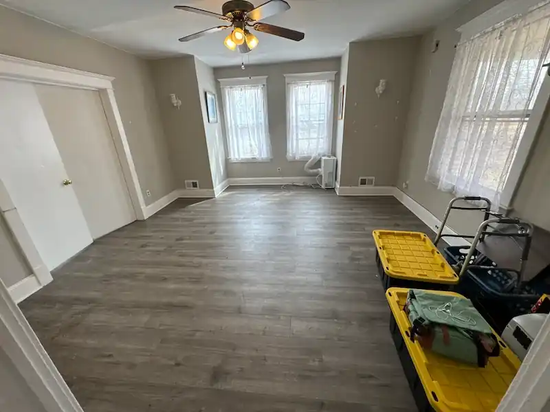 Jersey City apartment living room with plank flooring running wall to wall