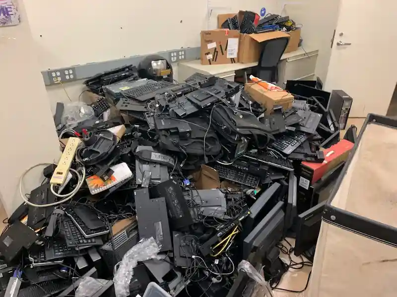 Pile of keyboards, monitors and cables set aside for e-waste recycling