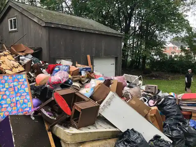 Phillipsburg yard covered in furniture, toys and bags beside the barn