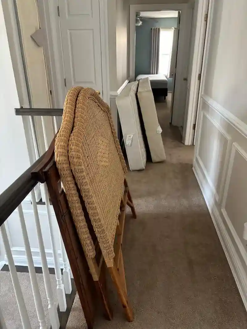 Madison hallway with a mattress and wicker headboard leaned against the wall